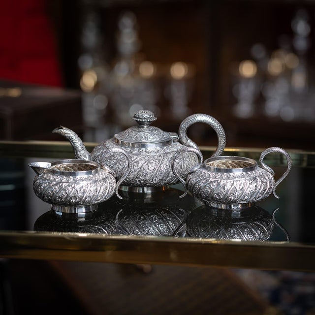 Antique late 19th century Indian Kutch solid silver three piece tea set, comprising a teapot, milk jug, and sugar bowl....