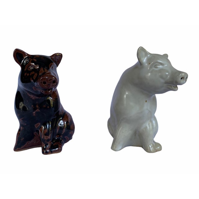 1970s ceramic salt and pepper shakers by Takakashi of Japan. Each one depicts a pig, one in a rust tone, the other off-white.