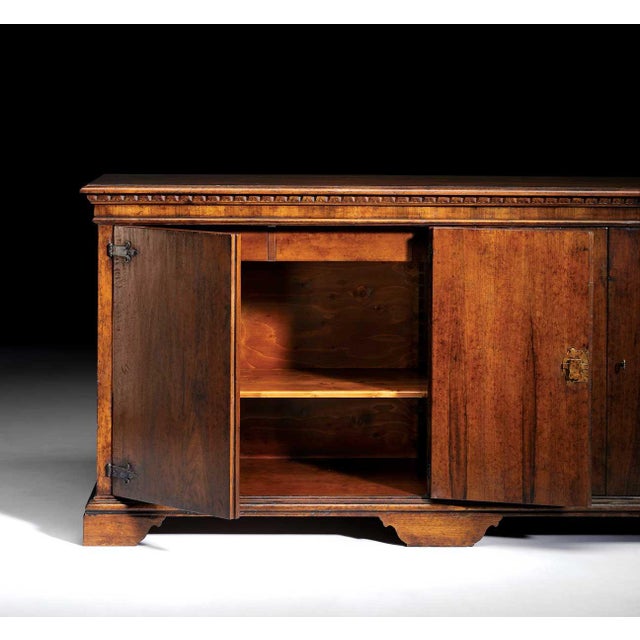 Handcrafted in Italy from solid walnut, this rustic sideboard features a distressed antique finish that highlights the...