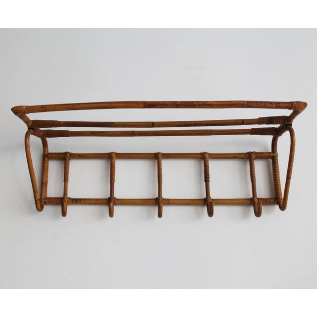 A beautifully crafted wall-mounted coat and hat rack produced in czechoslovakia during the 1960s and attributed to úluv...