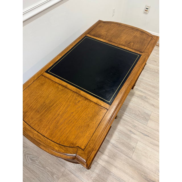 This vintage Mid-Century Drexel Esperanto Desk features a fruitwood frame and black leather top. Desk is heavily...