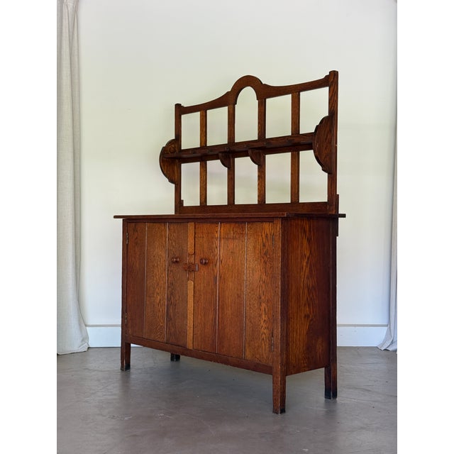 An English Arts and Crafts chestnut dresser attributed to Sir Ambrose Heal for Heal & Son of London, circa 1905, of the...