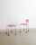 A rare contemporary "543 broadway" chair with a matching ottoman in red and yellow moulded resin seat and back, patinated...