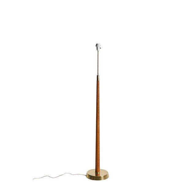 Floor lamp by Hans Bergström for Asea. The lamp is made from brass and wood, elegant design with stripes in the wood. This...