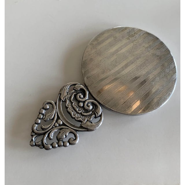 Hallmarked, this beautiful piece harks from an era gone by with wonderfully ornate silver detail.. The mirror section...