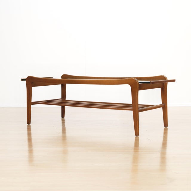 This elegant mid-century coffee table combines sculptural design with practical functionality. Crafted in beautifully...