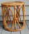 This small mid century round wicker table is very versitle. It can be used in almost every room for an extra accent table....