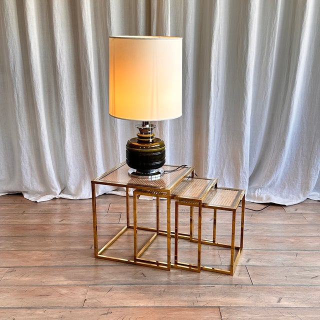 Breathtaking brass nesting tables with rattan and glass tops. Extreme elegance and multifunctionality in one set of...