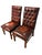 Pair of vintage Chesterfield-style side chairs with deep button-tufted backs, oxblood leather, and nailhead trim. Classic...