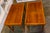 Elegant pair of Edwardian-style walnut side tables featuring intricate marquetry inlay and warm, rich wood tones....