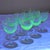 A set of 8 aperitif or sherry glasses made from glass containing uranium oxide—which produces that characteristic...