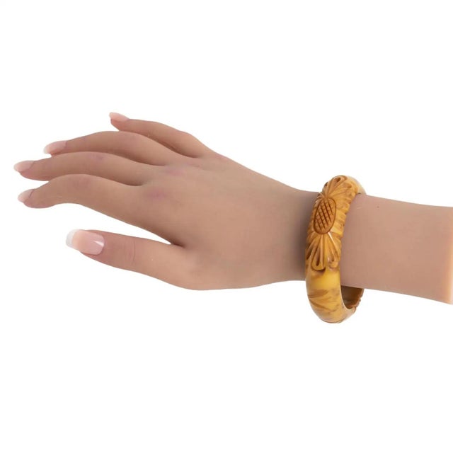 This stunning banana brown marble Bakelite carved bracelet bangle features a domed shape with deep floral carving, two...