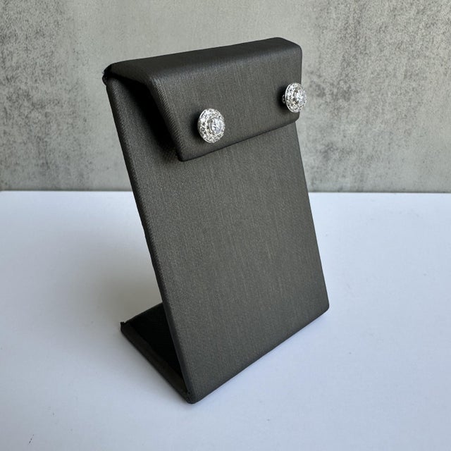 Enhance your jewelry collection with these sophisticated 14kt White Gold Diamond Halo Stud Earrings, featuring a total of...