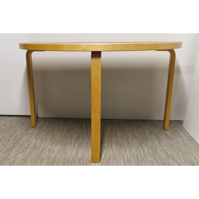 A versatile and timeless half-round dining table from Artek (unmarked), attributed to Alvar Aalto’s 1933 design, this...