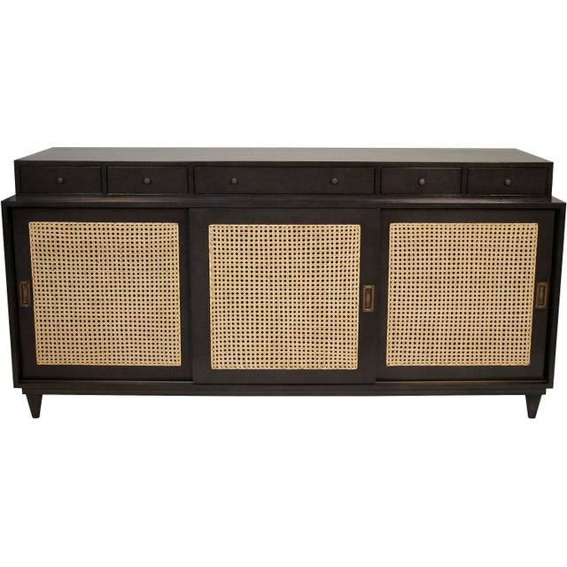 Handcrafted of mahogany with caned cupboards, stepped drawers and mid-century inspired legs, this oversized console has...