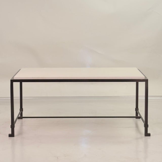 Dark bronze coated iron base fitted with a honed cream limestone top. Inspired by the timeless aesthetic of French modern...