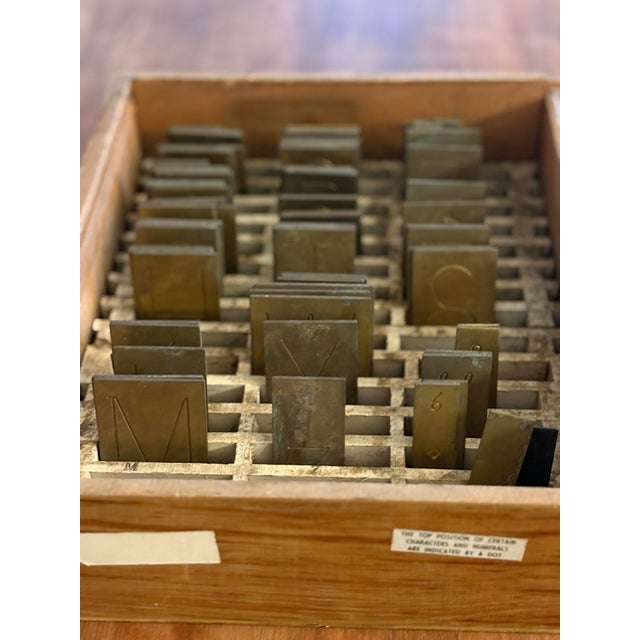 Offered is a vintage collection of 83 solid brass letterpress printing blocks housed in their original printer’s drawer...