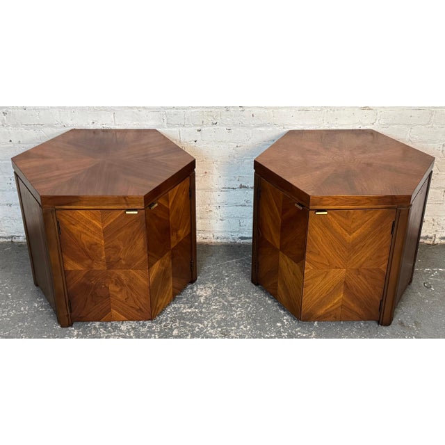 Pair of Mid-Century Modern hexagonal side tables by Lane Furniture. Featuring brass handles and two swinging doors on...