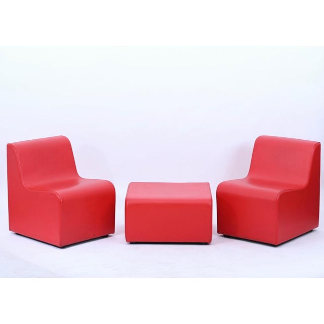 Beautiful red leatherette modular living room set composed by two chairs and a pouf. The set was produced in italy in...