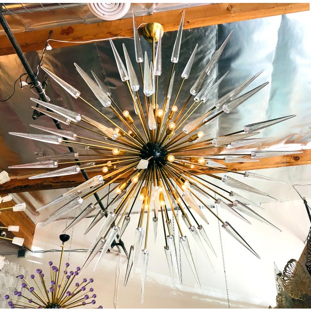 Italian modern sputnik chandelier with clear Murano glass shards spikes, mounted on natural unlacquered brass frame with...