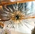 Italian modern sputnik chandelier with clear Murano glass shards spikes, mounted on natural unlacquered brass frame with...