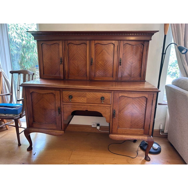 An elegant early 20th-century French walnut buffet à deux corps, featuring beautifully quarter-matched walnut veneered...