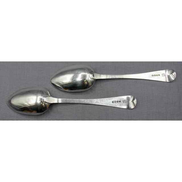1818 pair of sterling silver table or serving spoons, London, England. A handsome pair in the "Old English" pattern, made...