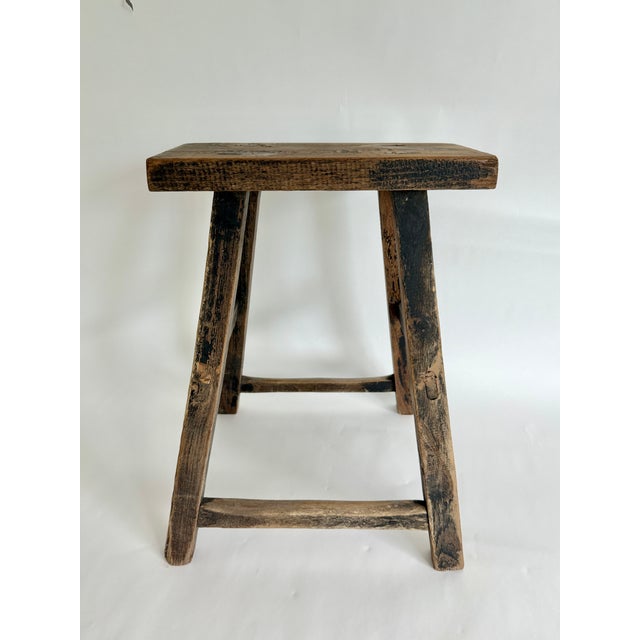 Antique Chinese rustic elongated stool hand-constructed from elm wood using the mortise and tenon method. Age and...