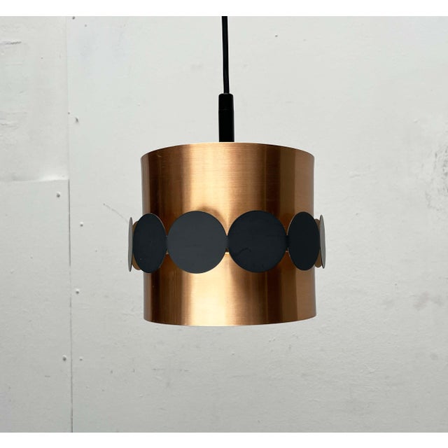 Metal pendant lamp by the renowned manufacturer Doria Leuchten. The lamp consists of a two-part cylinder as its base. The...