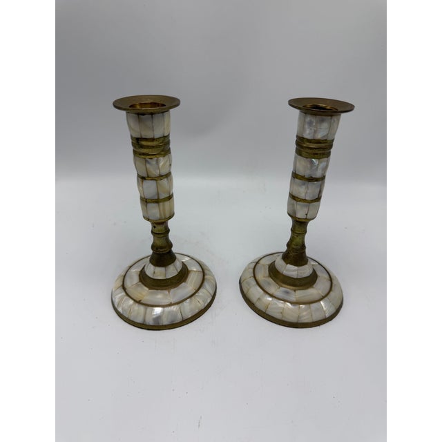 This is a lovely pair of vintage mother-of-pearl and brass candlesticks, featuring slender column-form bodies beautifully...