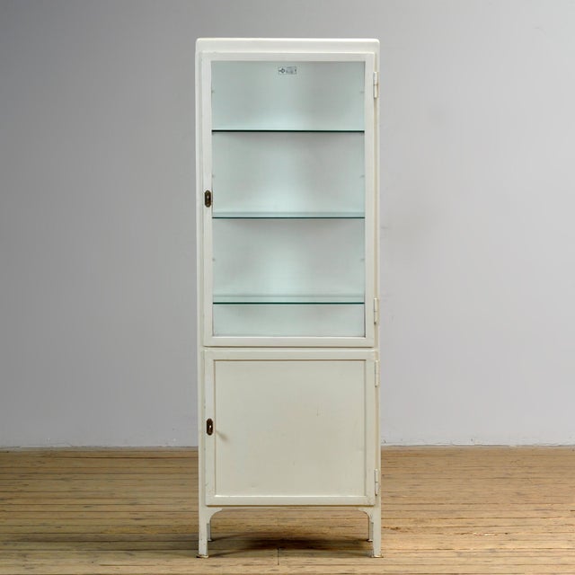 This Polish medicine cabinet from 1975 combines functional industrial design with a historical look. Manufactured by...