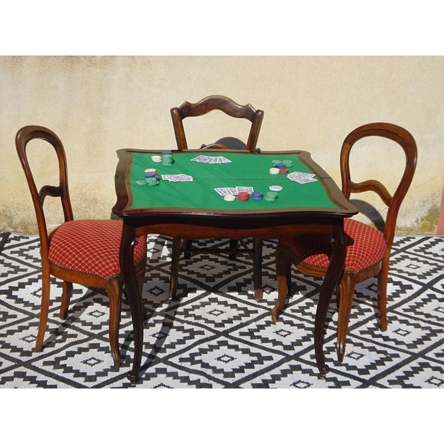 Console table that unfolds into a games table. Antique piece from the late 19th century, crafted from solid mahogany....