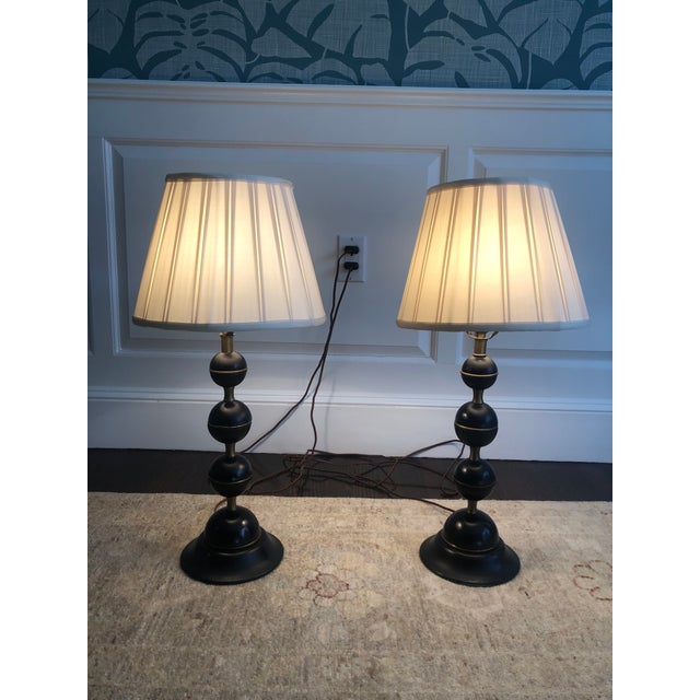 A pair of brass and wooden stacked ball table lamps with silk empire gather pleated lamps shades from the Oriental Lamp...