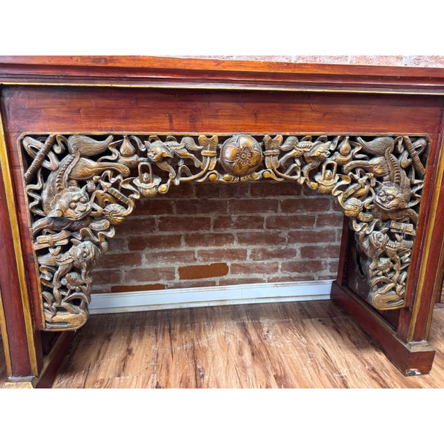 Monumental Chinese altar or console table in the traditional qiaotouan form, distinguished by its long planked top and...
