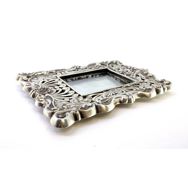Silver Frame with Shell Reliefs and Support Stand, in Very Good conditions. Designed 1920 to 1949 This piece has an...