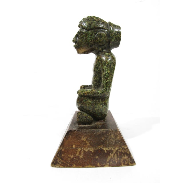 Decorative Aztec-inspired / Pre-Columbian style seated figure statue mounted on a wood base. The figure has a green stone-...