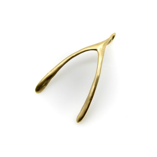 This vintage 14k gold pendant is in the shape of a wishbone. Though the tradition is popular in the United States, the...