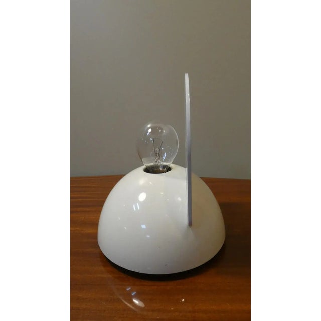 Buco wall light designed by Claudio Dini for Artemide in 1974, in full space age style. Polycarbonate base and ivory-...