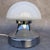 A stunning Italian mushroom-shaped table lamp dating from the 1970s. It features a chrome-plated silver metal frame and...