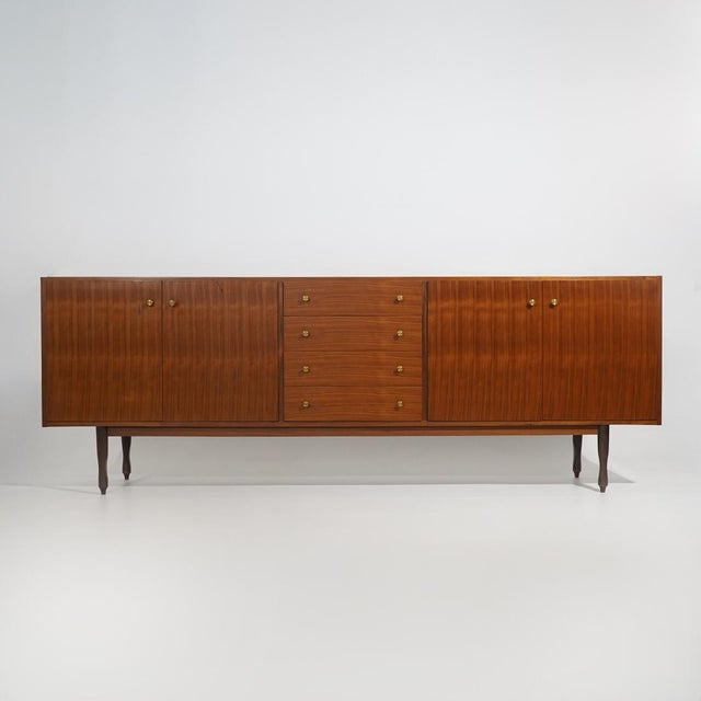 An Italian sideboard from the 1960s, characterised by elongated proportions and an essential design reflecting the...