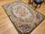 5’ 9” x 8’ 10” (69” x 106”) Vintage American hand hooked room size rug in floral pattern circa the early 20th century. The...
