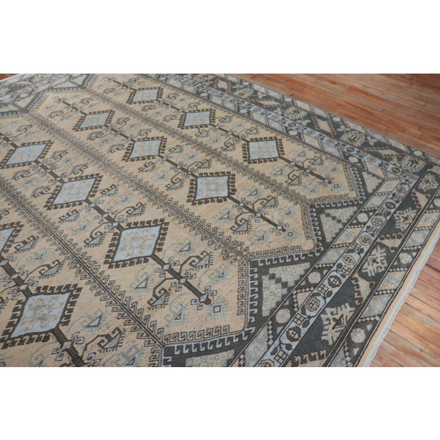 A mid-20th-century Turkish Anatolian Rug with an all-over tribal geometric design with charcoal and light blue accents on...