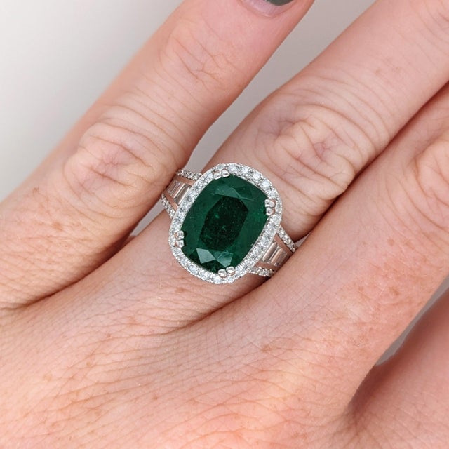 This beautiful ring features a 5.6 carat cushion cut Emerald gemstone with natural earth mined diamonds set in solid 14K...