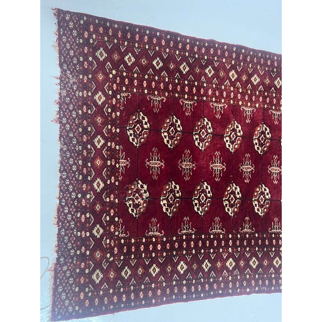 Antique wool rug with decorative motifs on a red background. Used condition, see photos. Dimensions: 180 x 98 cm 20th century