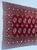 Antique wool rug with decorative motifs on a red background. Used condition, see photos. Dimensions: 180 x 98 cm 20th century