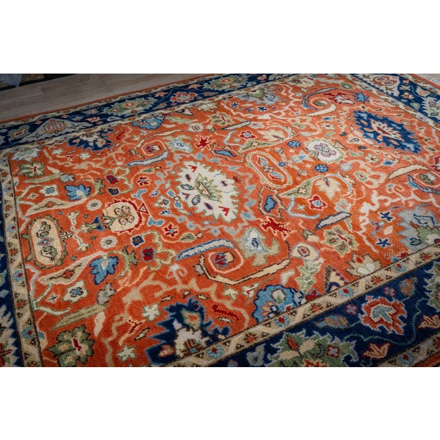 A hand-knotted wool Oushak, made in India and measuring 8' x 10'. Oushak weaving is known for large-scale, softly drawn...