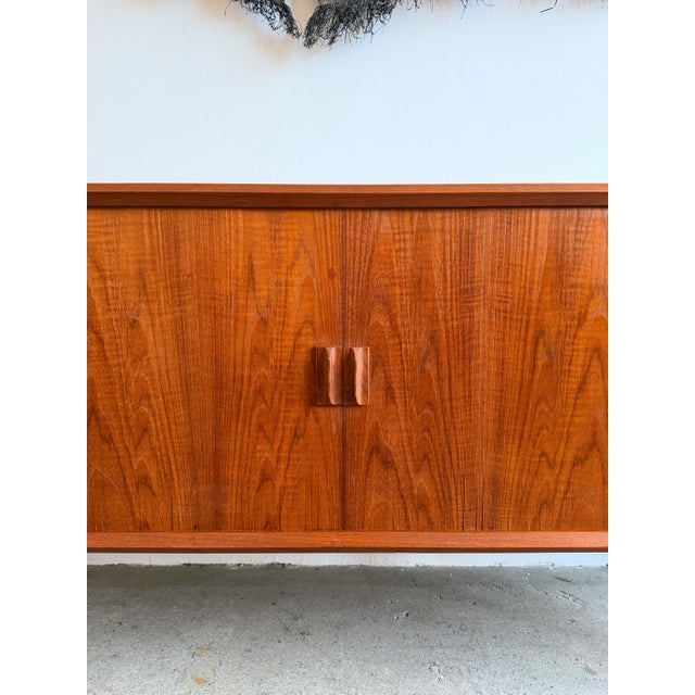 A Danish modern credenza designed by Svend Aage Larsen and produced by Faarup Møbelfabrik in Denmark, circa 1960s....