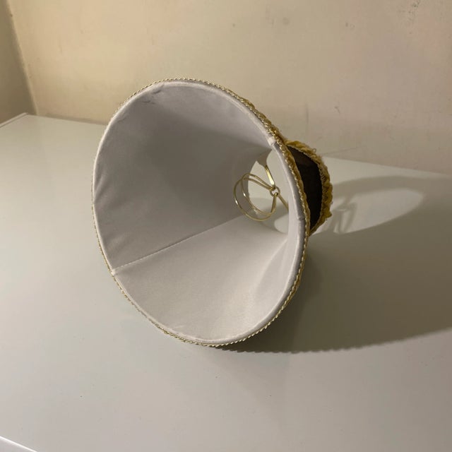 High quality empire bell style lampshade with outer in black fabric with gold braided border. Interior of white satin....
