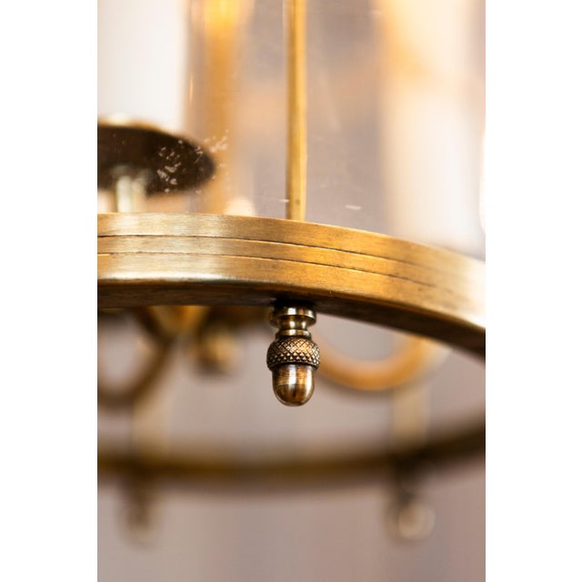 This elegant early 20th-century French lantern features a beautifully structured brass frame with graceful curves and...