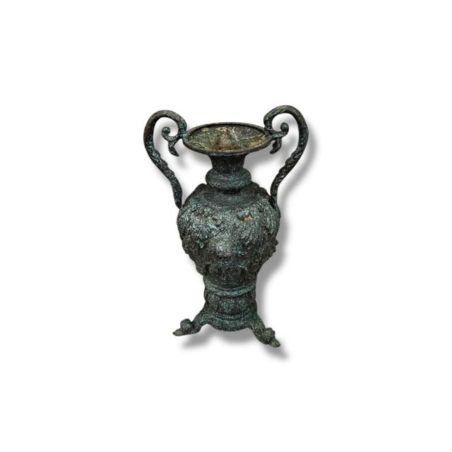This cast iron vessel with a natural verdegris patina brings timeless old-world character to any space. Featuring elegant...